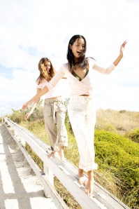 Young Women Smiling Walking on a Railing