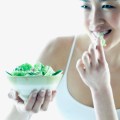 Young woman eating&nbsp;salad